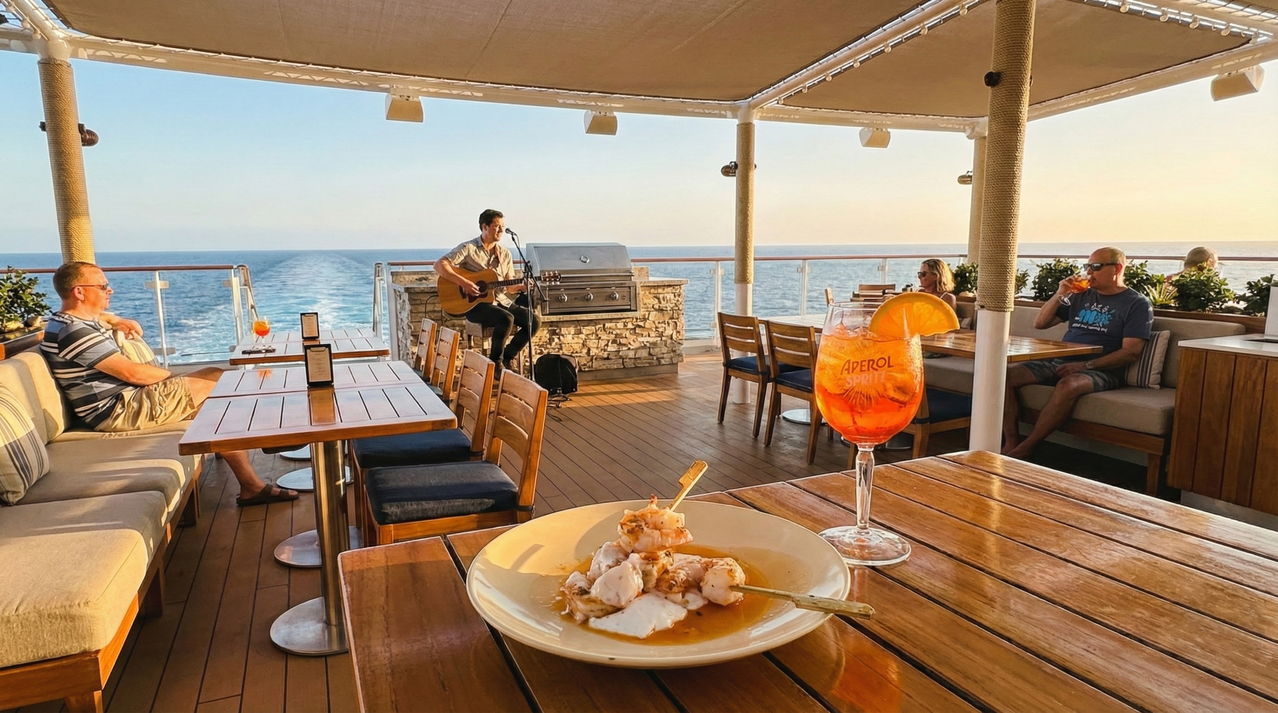 Grilled shrimp and cocktail at The Dock on Virgin Voyages with ocean wake views at golden hour
